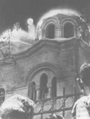 Photo: online image, apparition of a figue clad in robe and halo near the dome of the church.